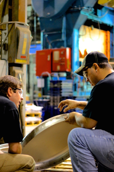 Two Sharpsville Container employees discussing a pressure vessel