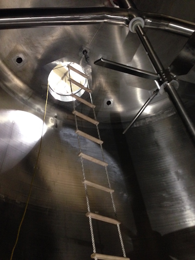 A ladder hanging inside of a mixing and agitation tank